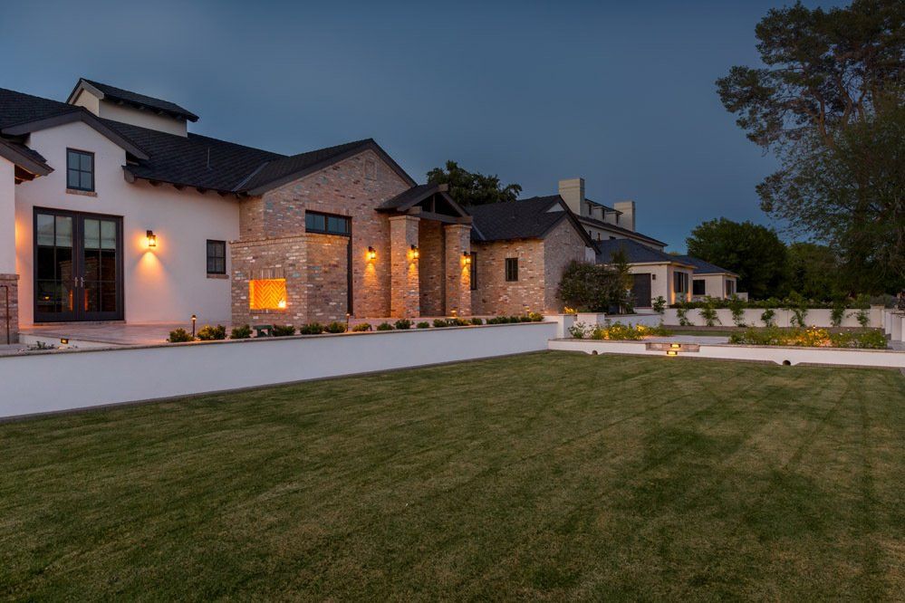 A large house with a large lawn in front of it.