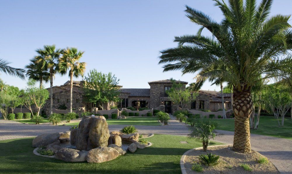 A large house with palm trees in front of it