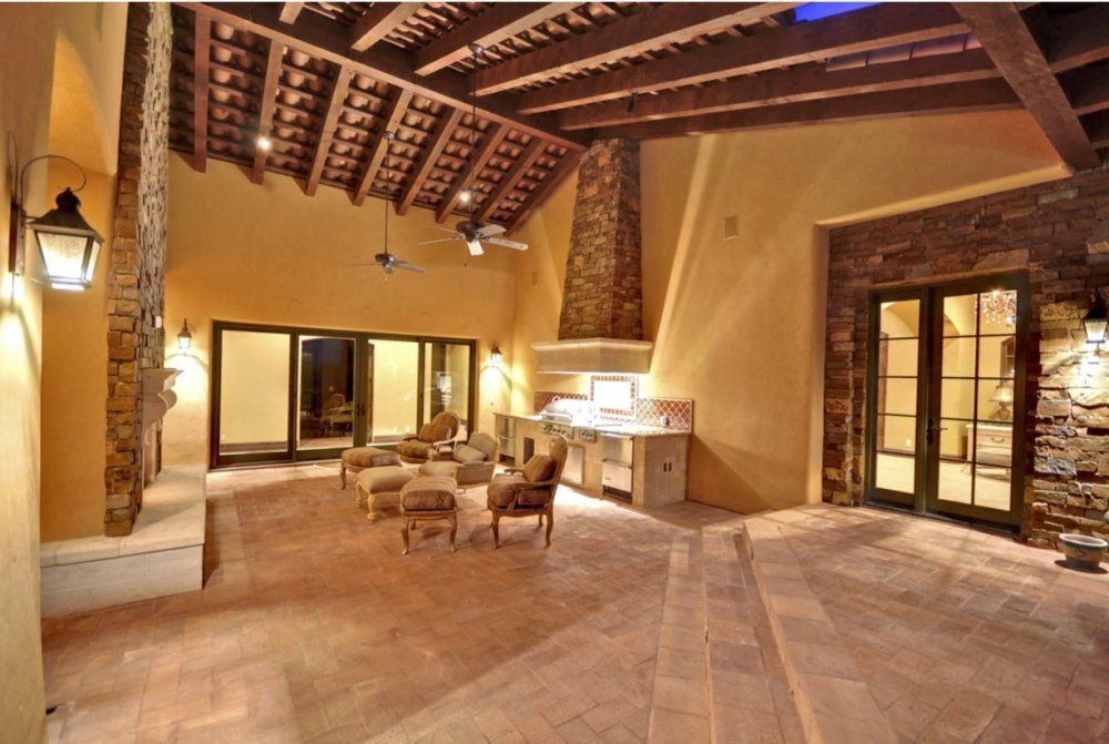 A large room with a ceiling fan and a fireplace