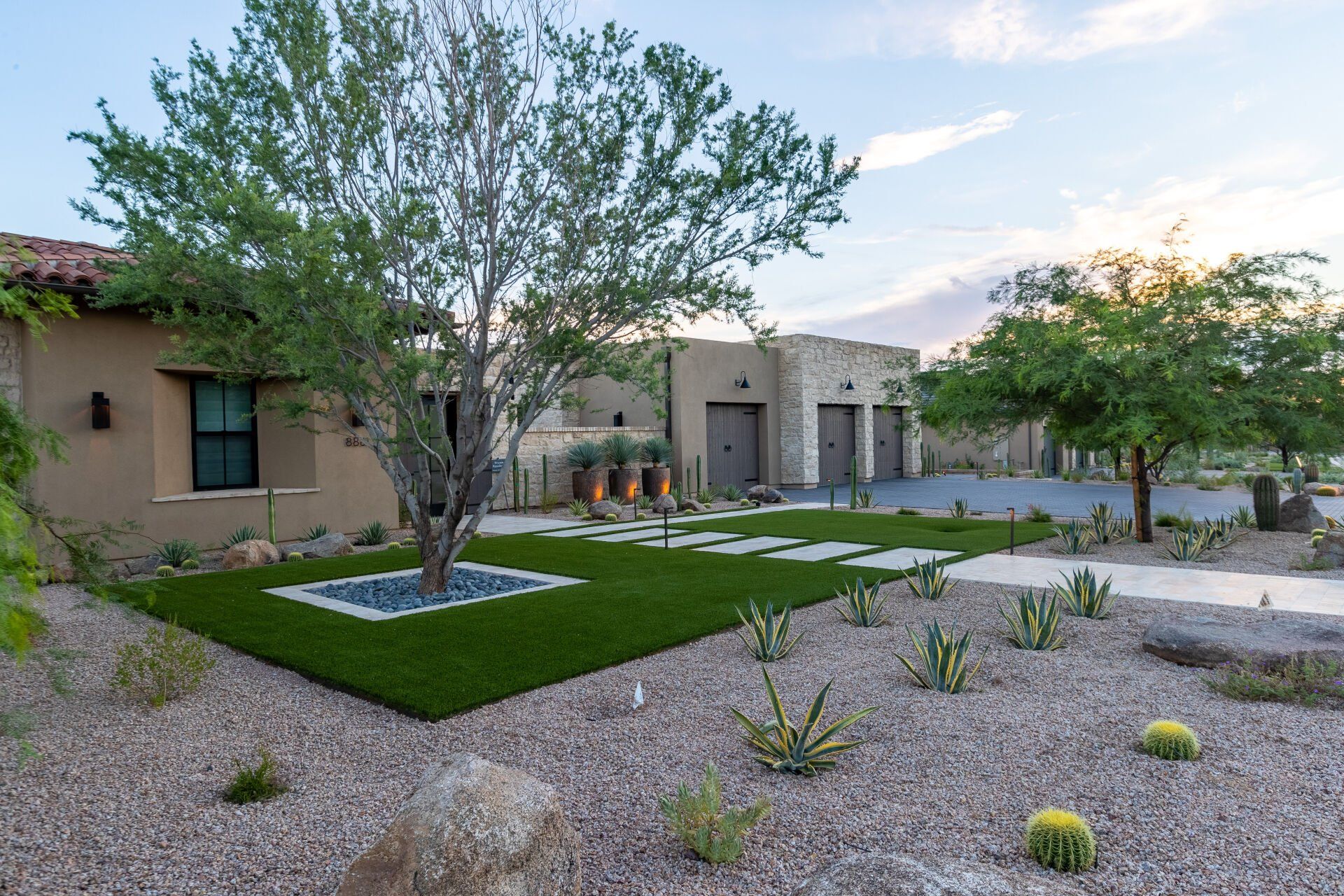 A large house with a lush green lawn in front of it.