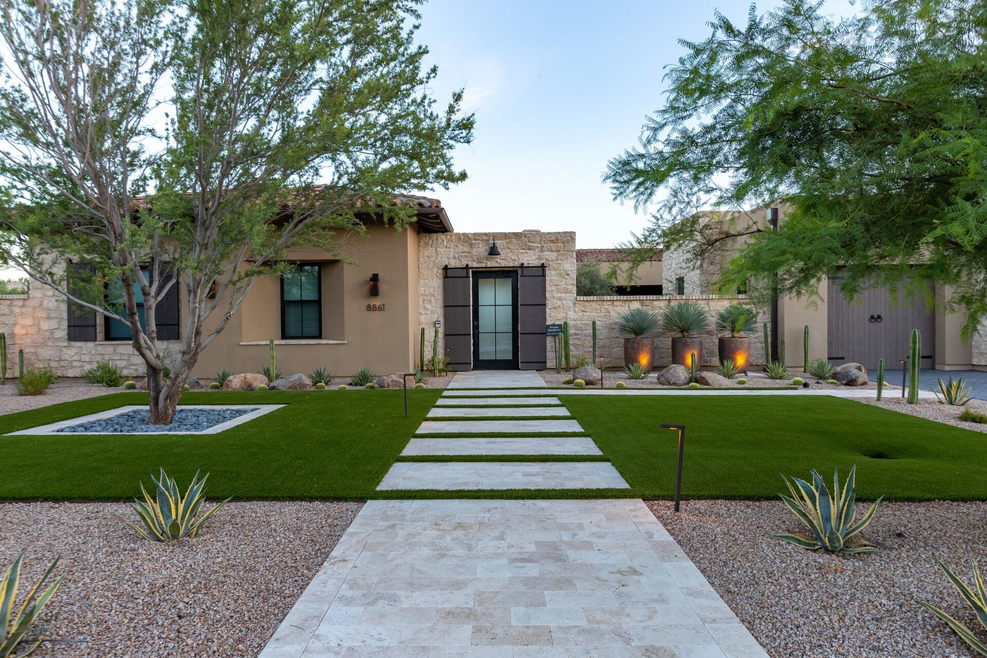 The front of a house with a walkway leading to it.