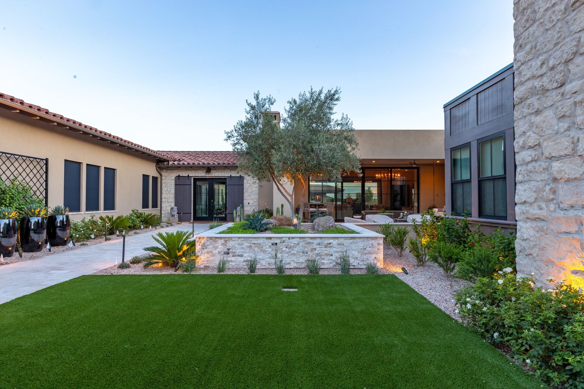 A large house with a lush green lawn in front of it.
