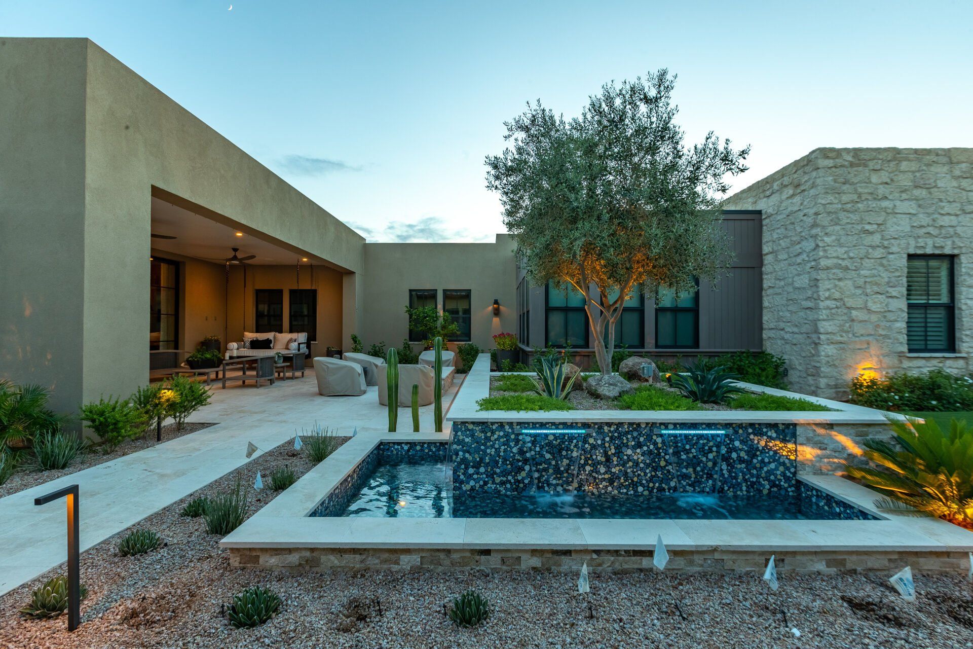 A large house with a swimming pool in front of it.