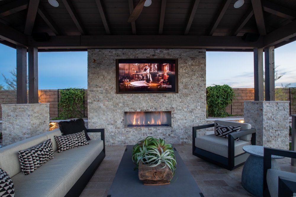 A living room with a fireplace and a flat screen tv