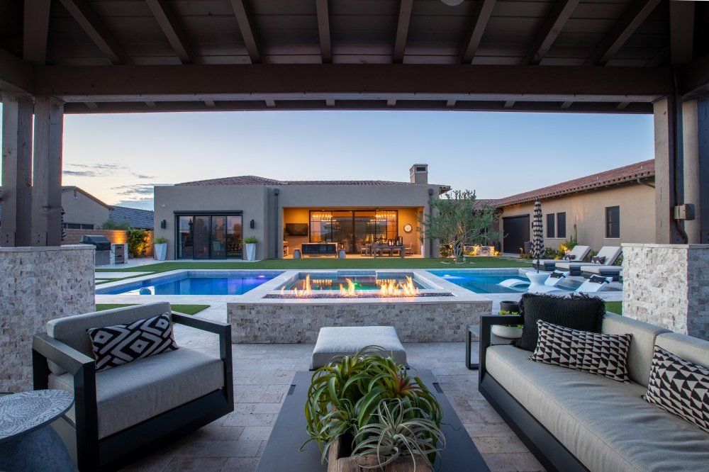 There is a fire pit in the backyard of a house.