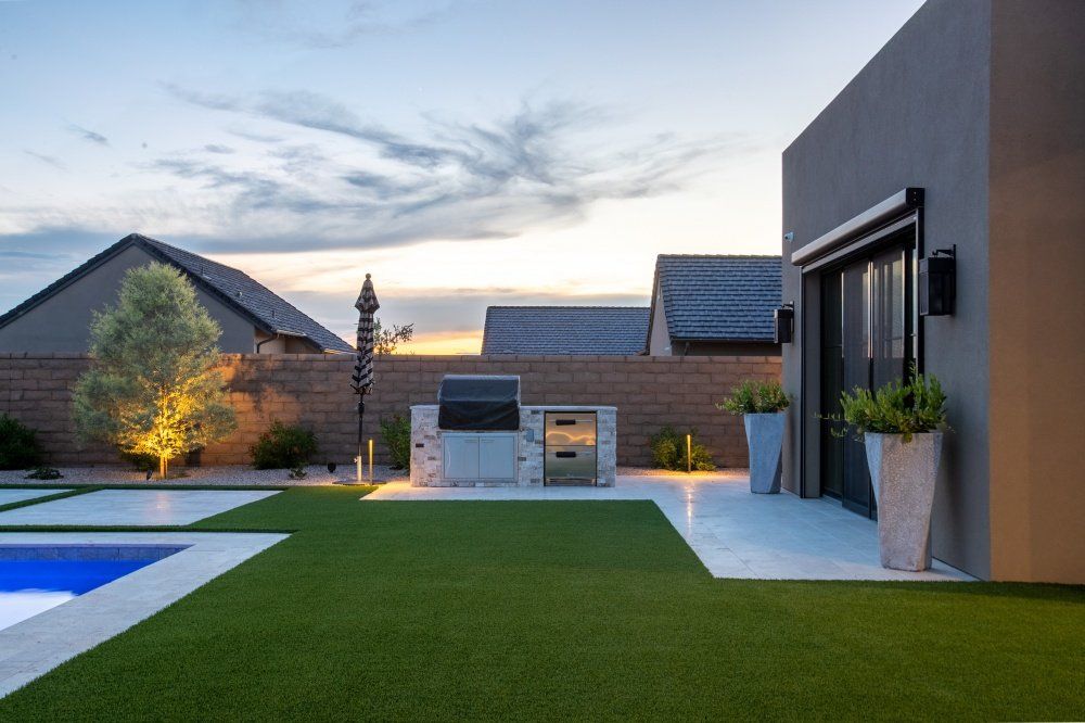 There is a swimming pool in the backyard of a house.