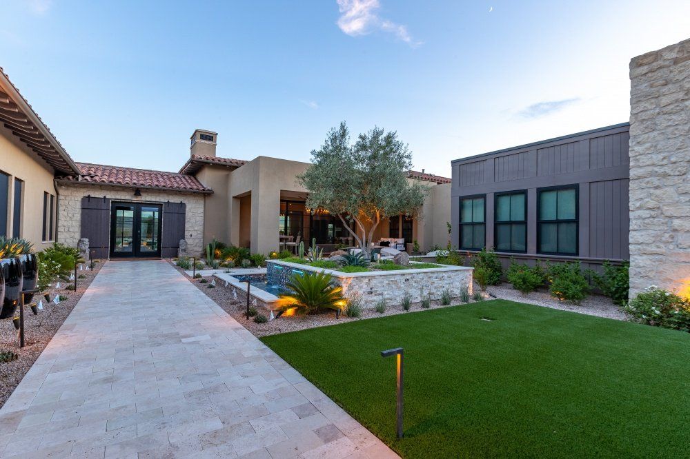 A large house with a large lawn in front of it.