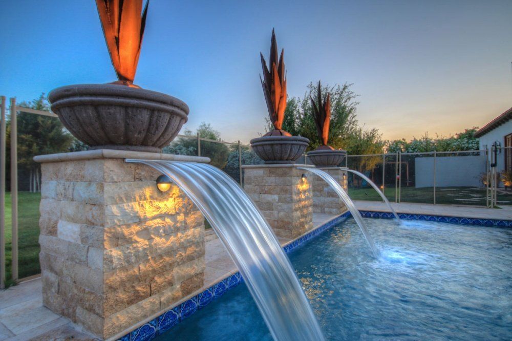 There is a waterfall in the middle of the pool.