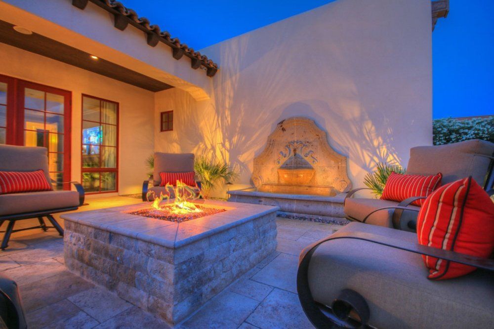 There is a fire pit in the middle of the patio.