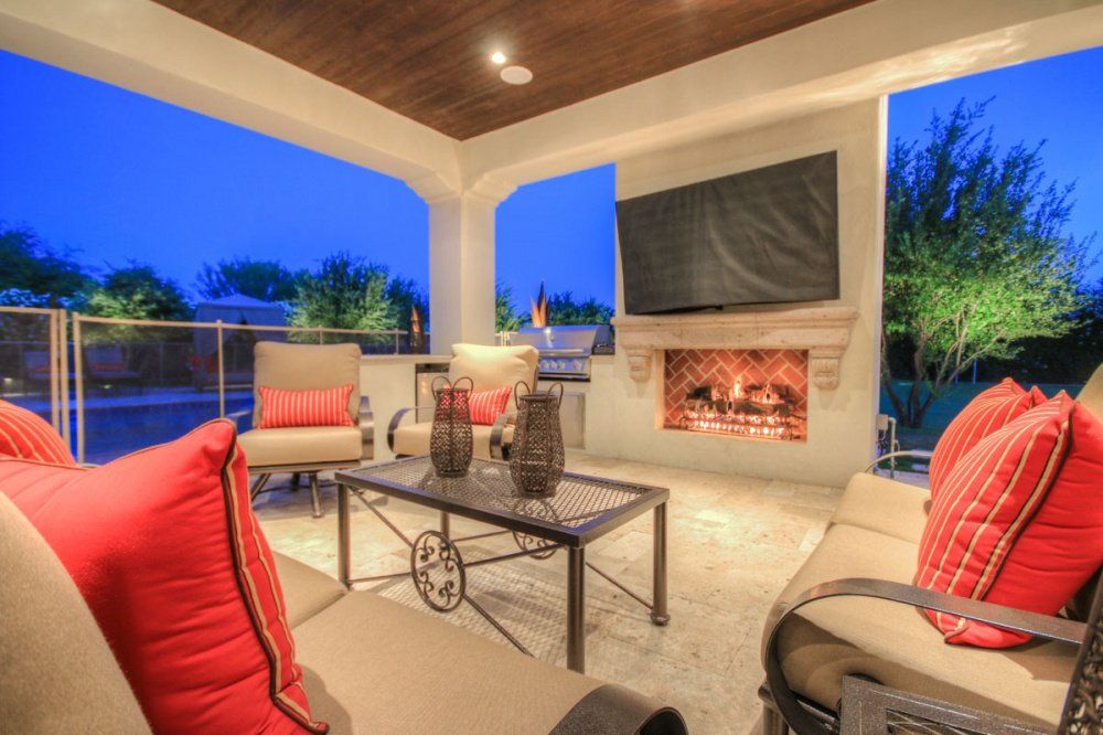 A living room with a fireplace and a flat screen tv