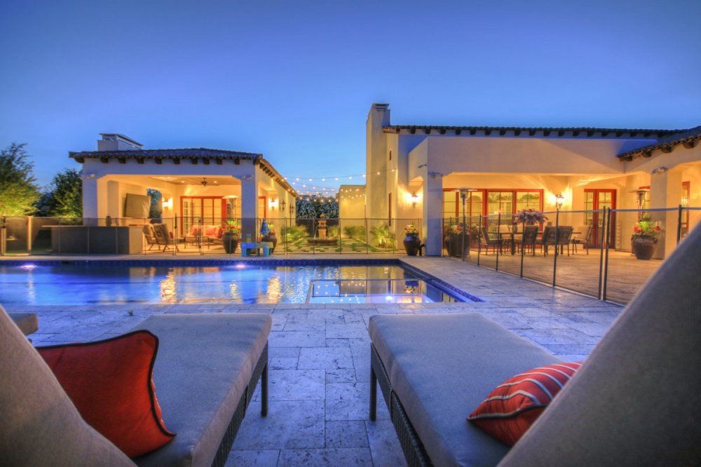 A large house with a swimming pool in front of it