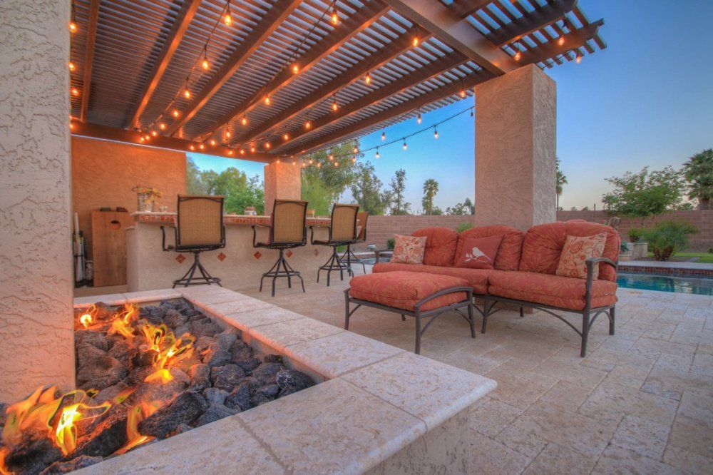 There is a fire pit in the middle of the patio.