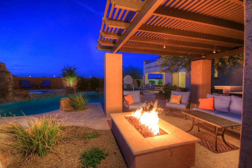 There is a fire pit in the middle of the patio.