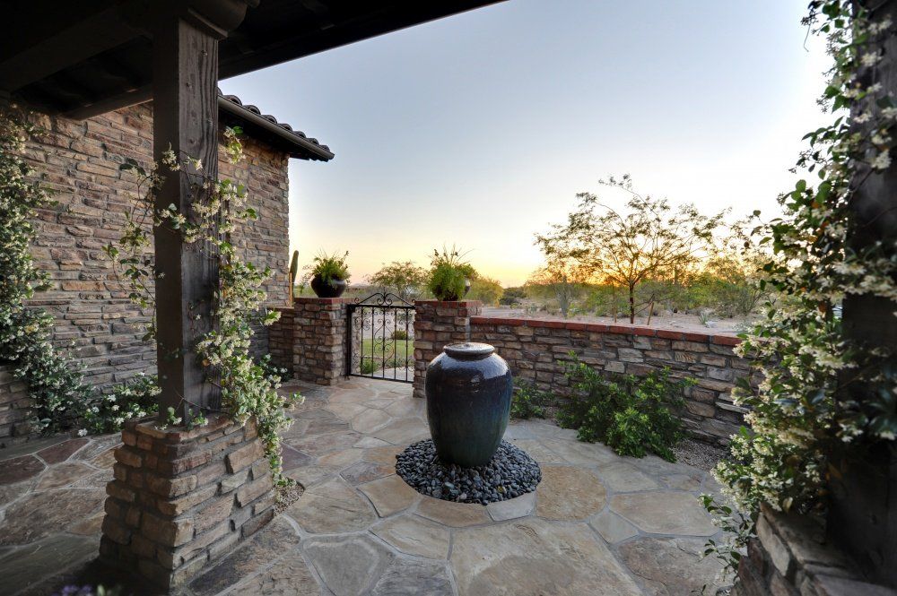 A patio with a large vase in the middle of it