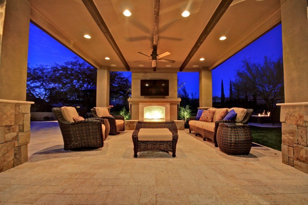 A living room with furniture and a fireplace at night