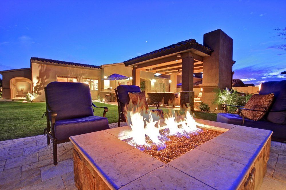 There is a fire pit in the middle of the patio.