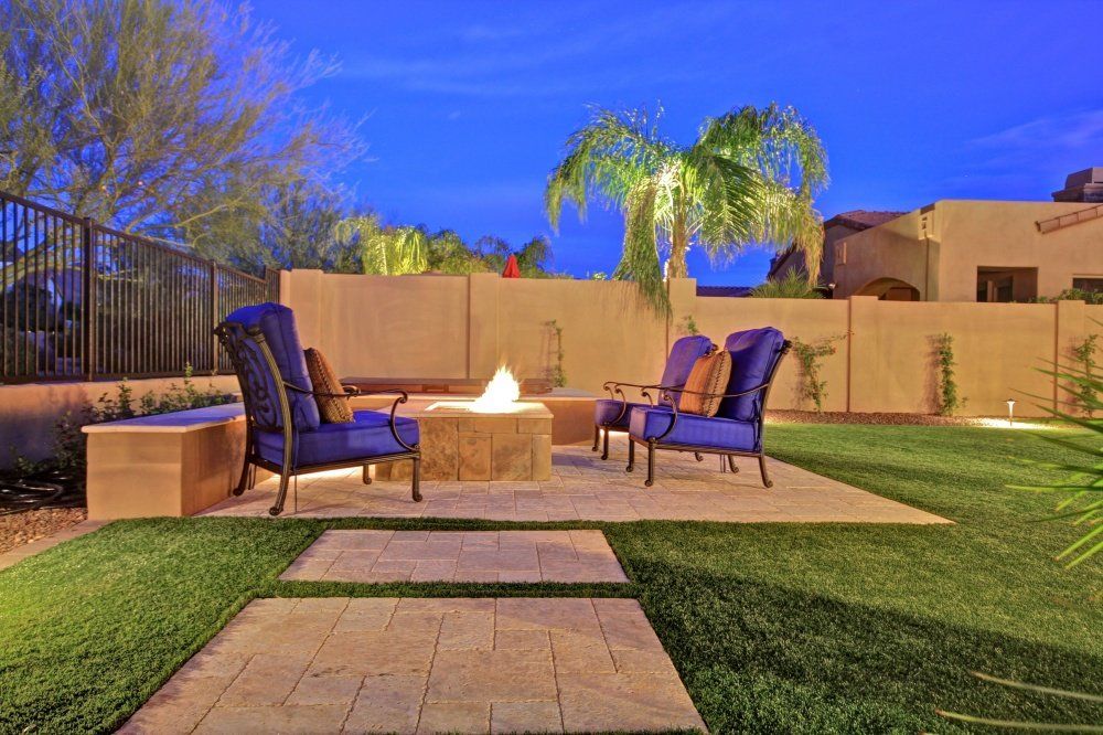 There is a fire pit in the middle of the backyard.