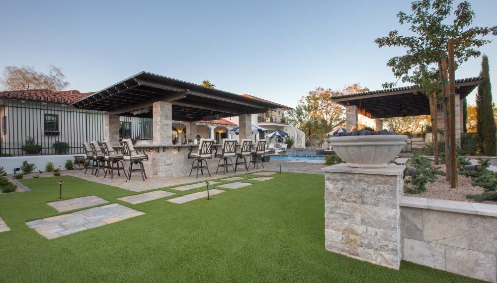 A large backyard with a patio area and a pool.