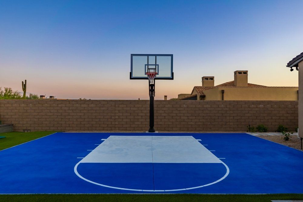 A blue and white basketball court with a basketball hoop
