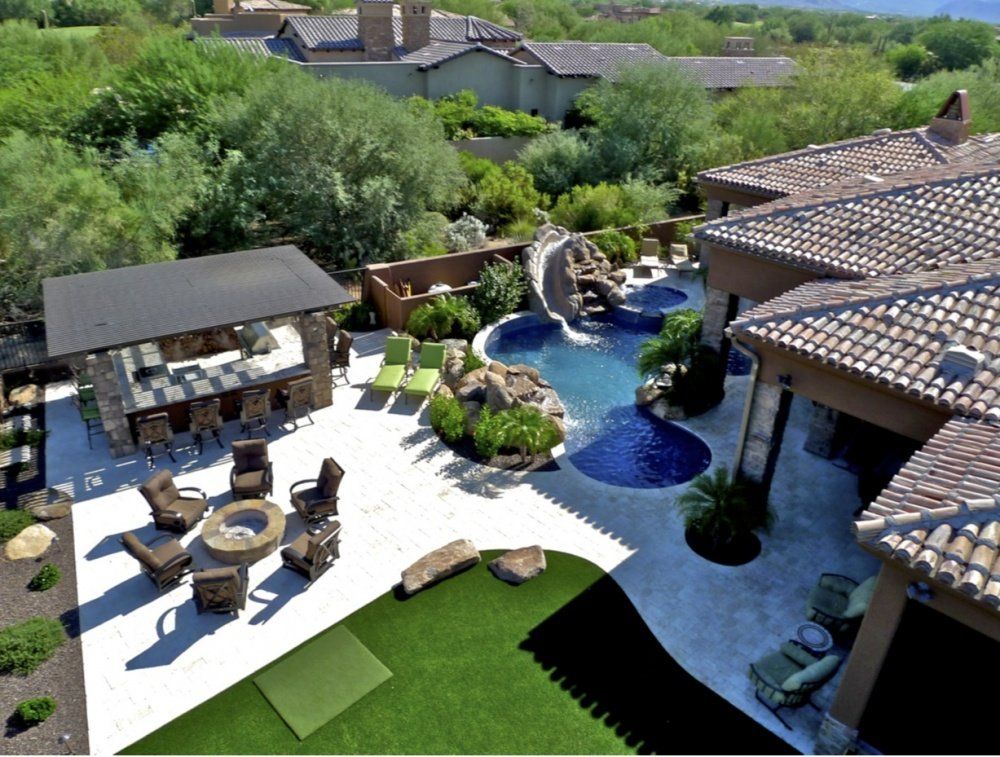 An aerial view of a large house with a swimming pool