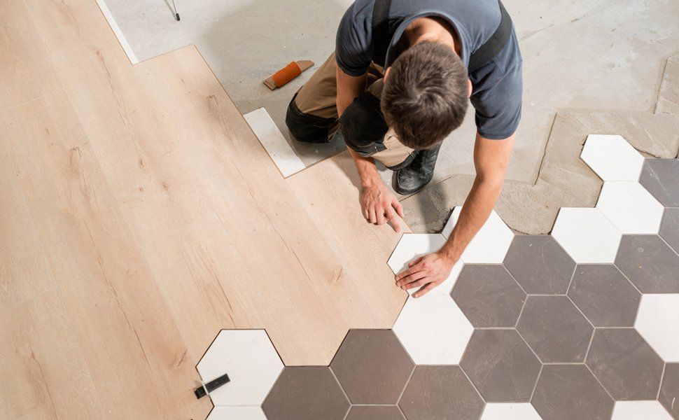 Worker Installing Wooden Floor — Worcester County, MA — Cassa Kitchen & Bath Design & Remodeling Center