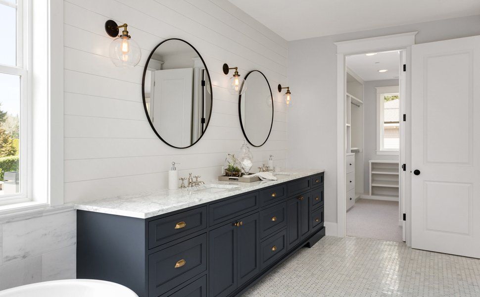 Bathroom With Dark Blue Cabinets — Worcester County, MA — Cassa Kitchen & Bath Design & Remodeling Center