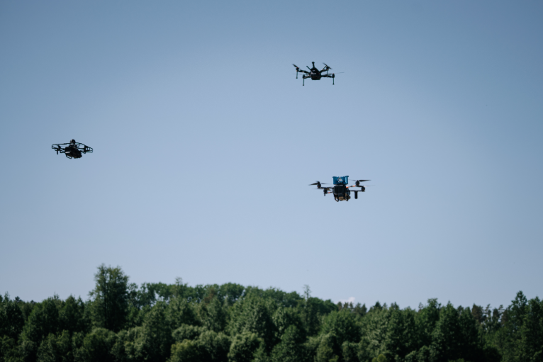 mage of three drones in the sky