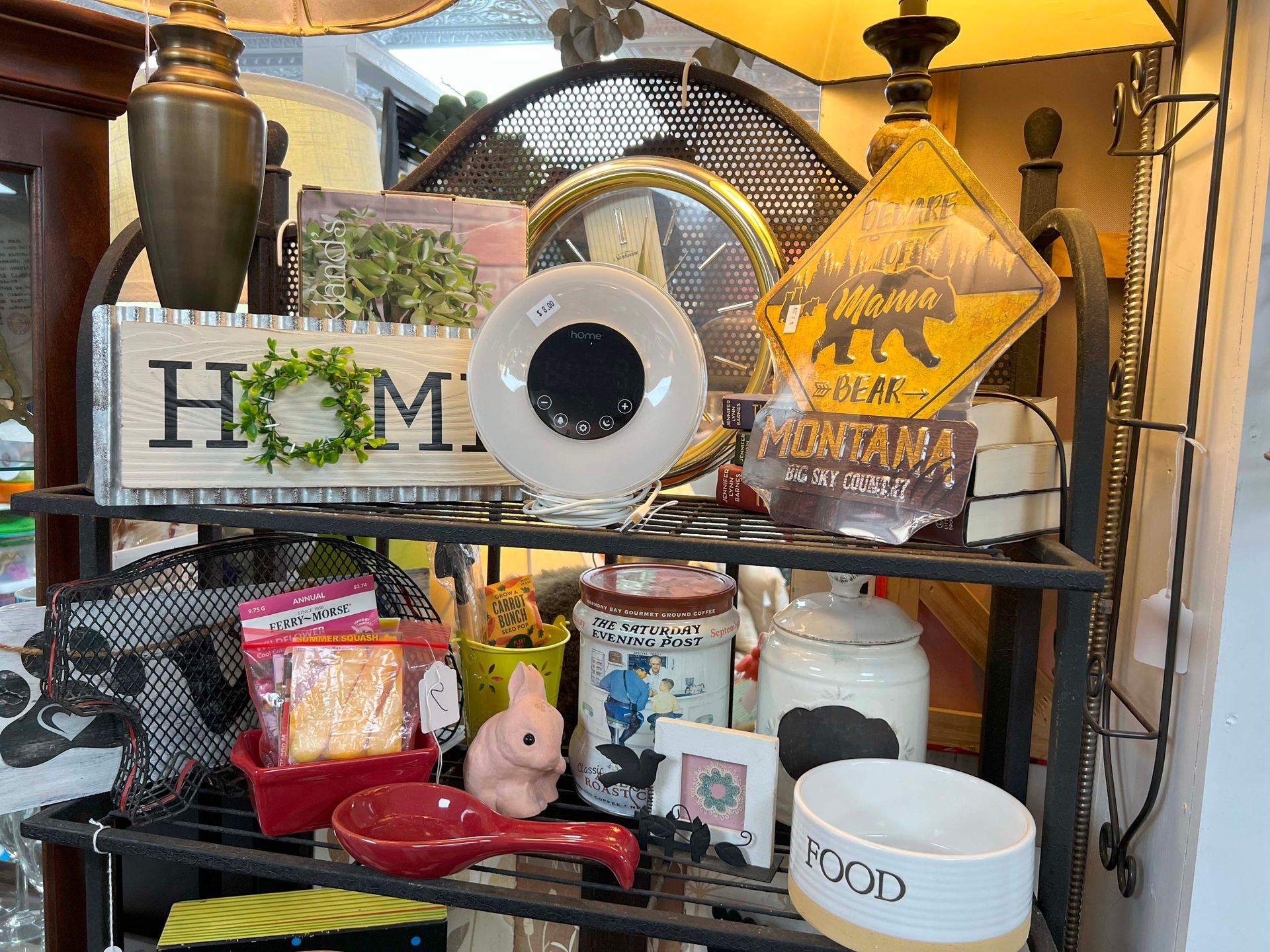 A shelf filled with lots of items including a sign that says `` home ''.
