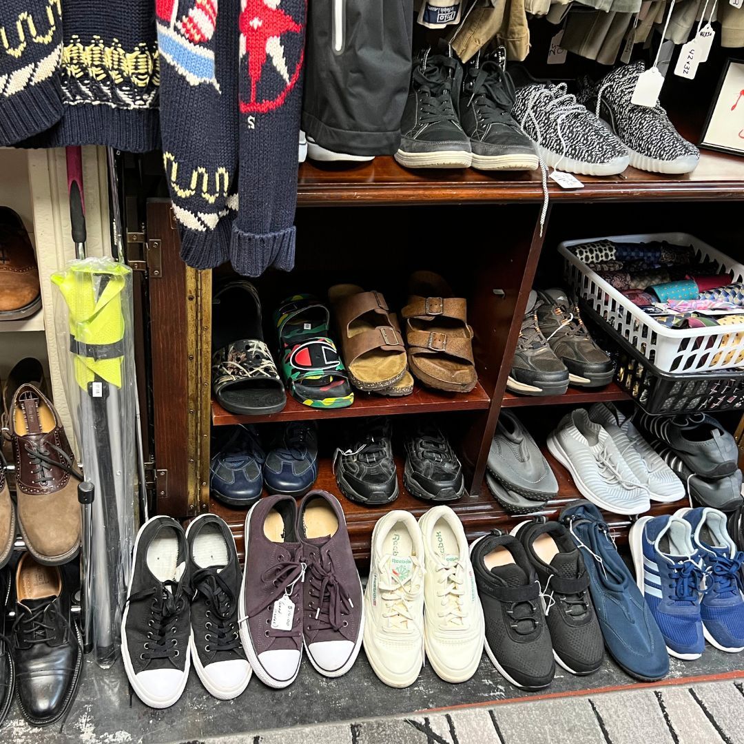 A shelf filled with lots of shoes and clothes.
