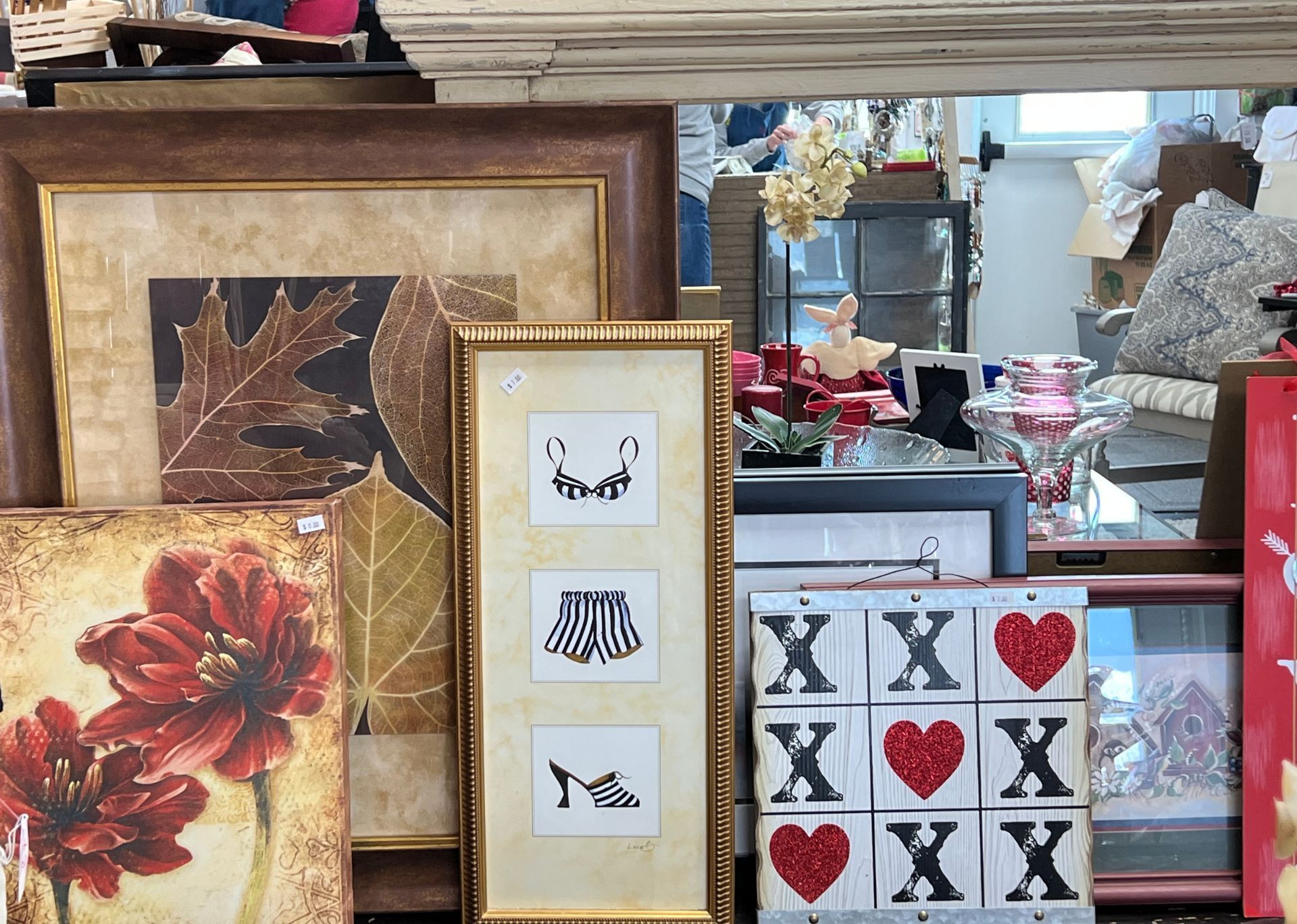 A bunch of framed pictures are sitting on a table