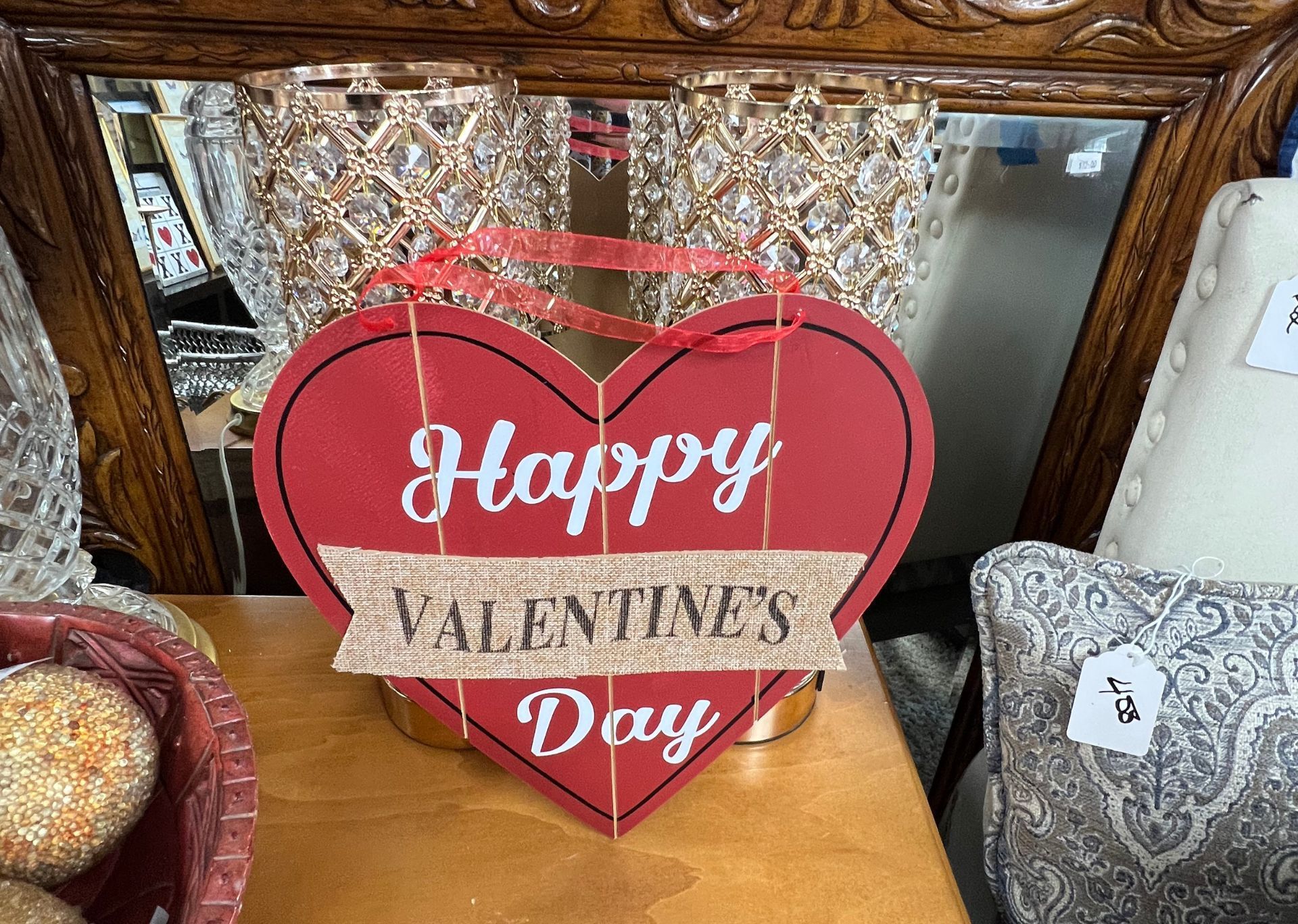 A red heart shaped sign that says happy valentine 's day