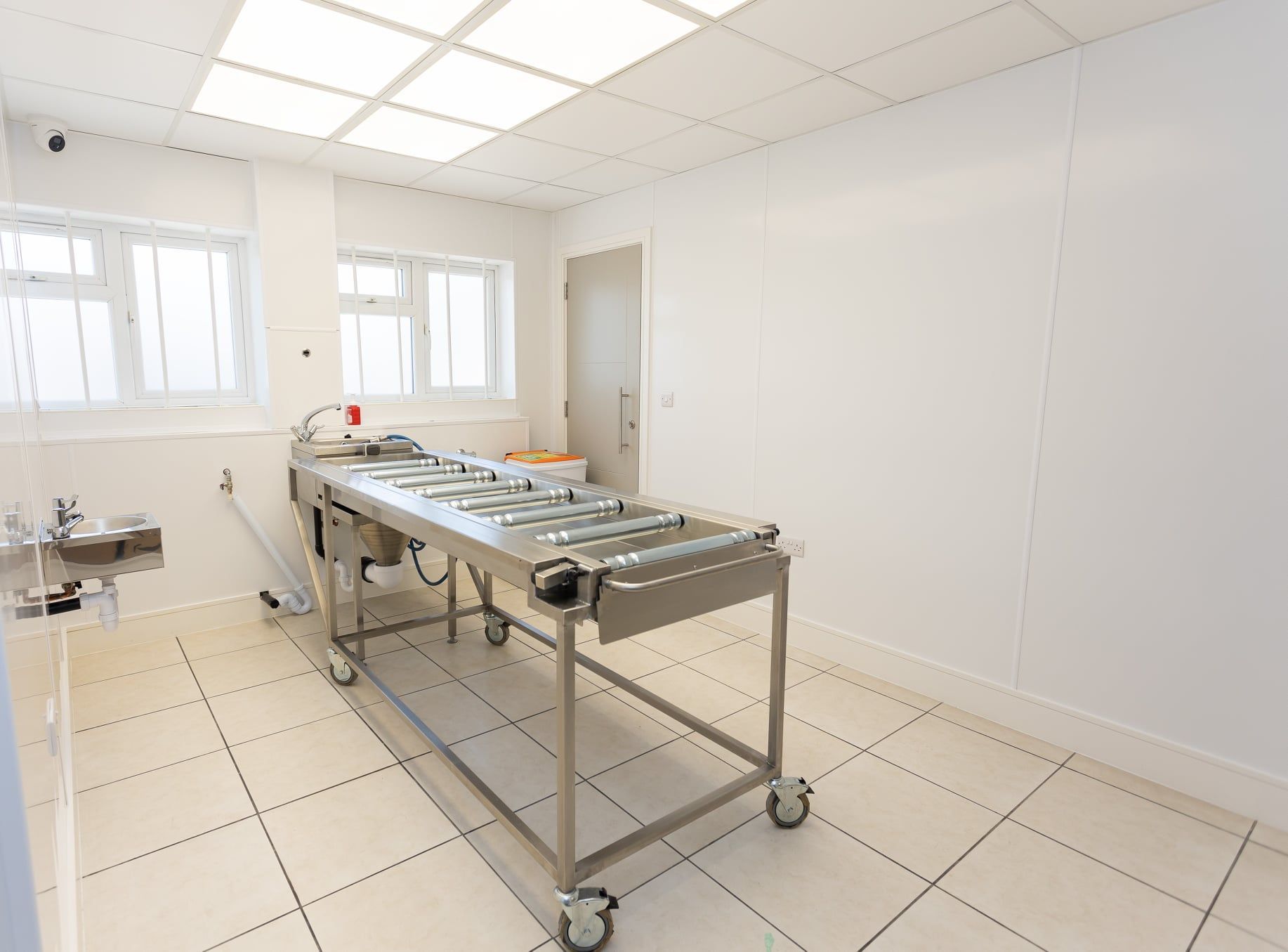 There is a table with wheels in the middle of the room.