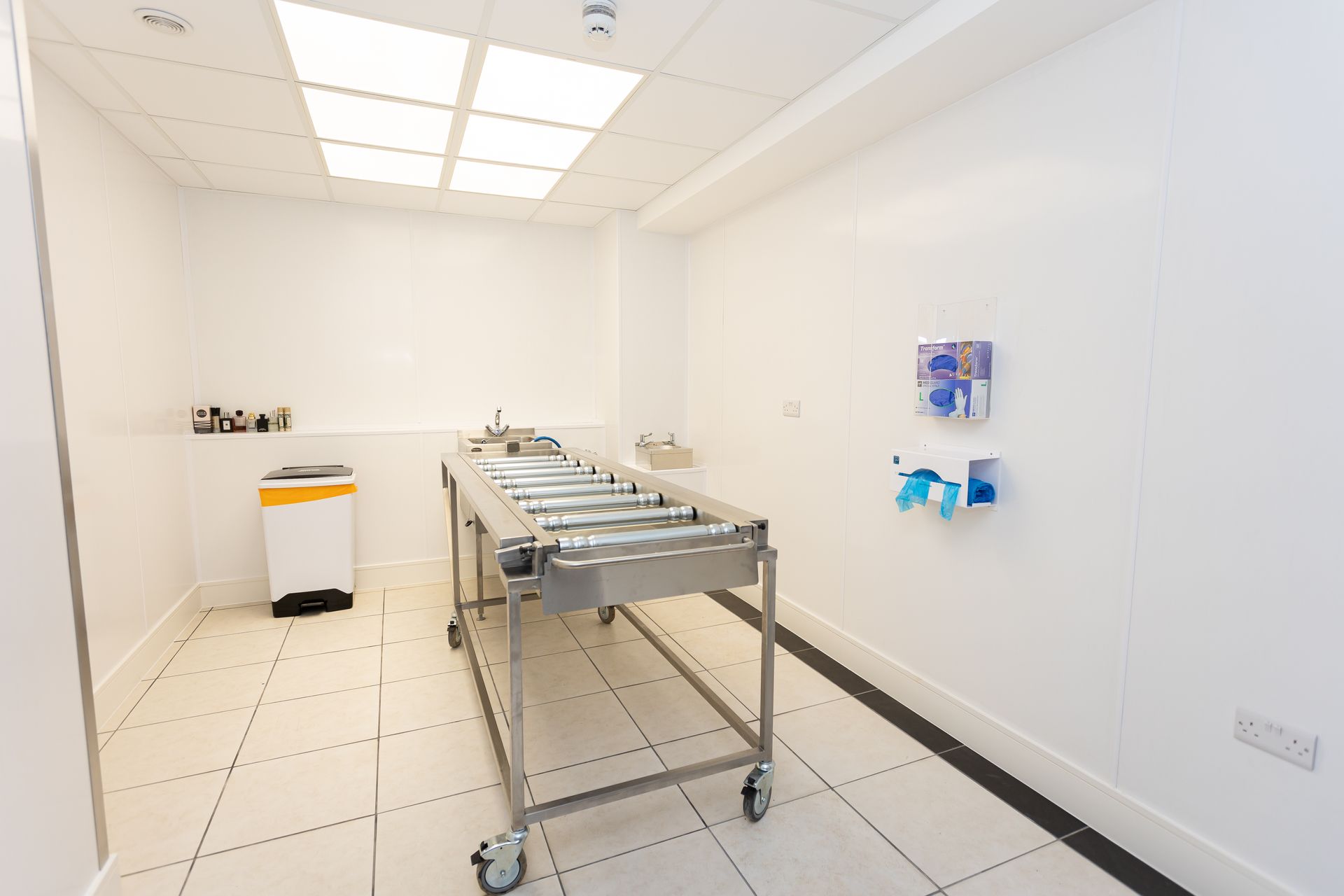A small room with a bench and black shelves.
