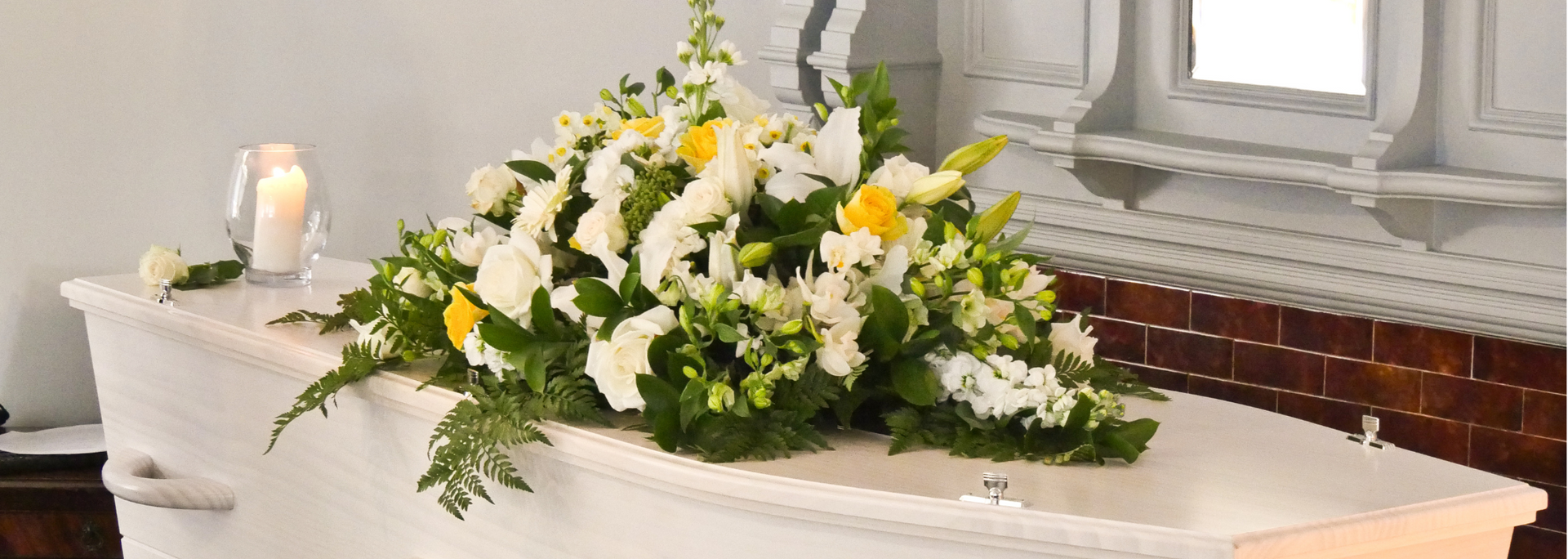 Picture of a closed coffin adorned with flowers. Picture of a closed coffin adorned with flowers.