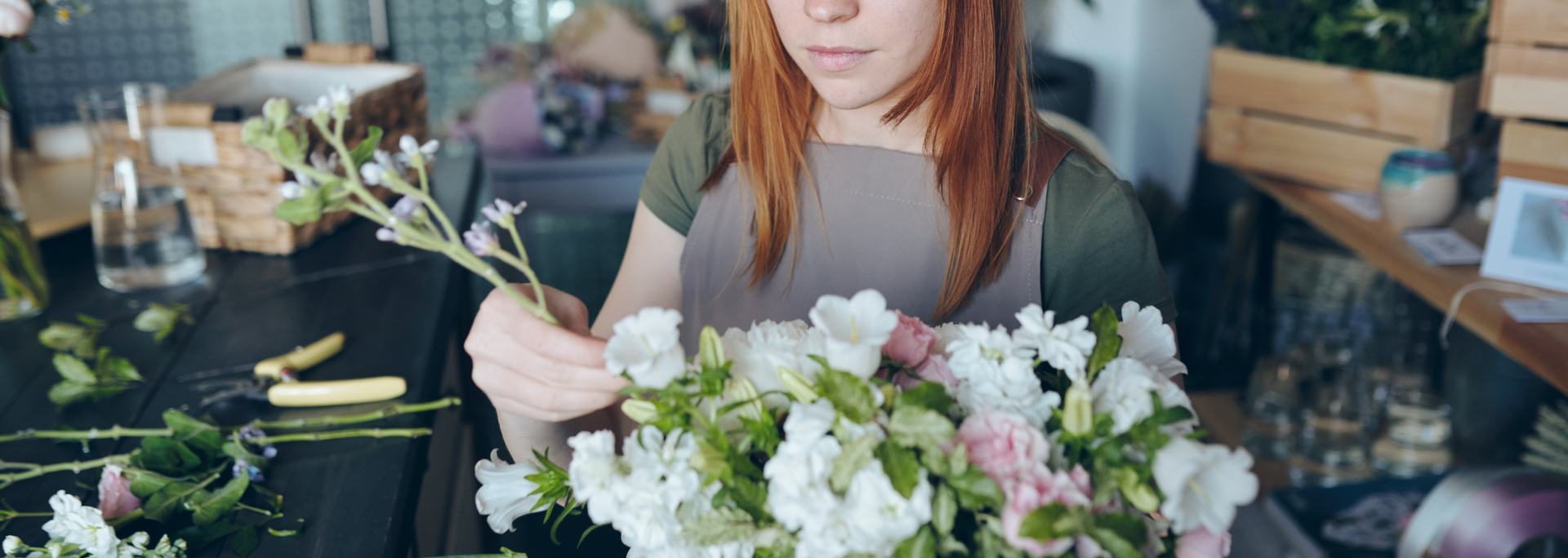 Picture of a person arranging flowers. 