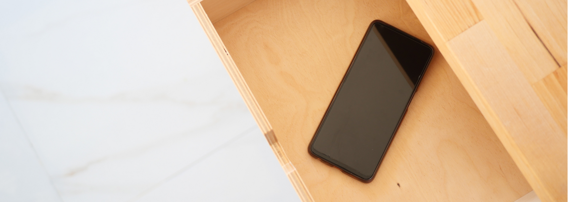 Picture of a smartphone in a drawer. Picture of a smartphone in a drawer.