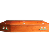 A wooden coffin is sitting on a white surface.