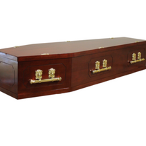 A wooden coffin with gold handles on a white background