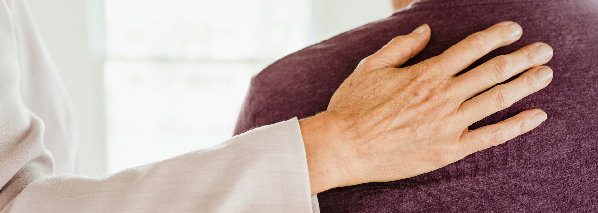 Picture of hand on someones shoulder. 