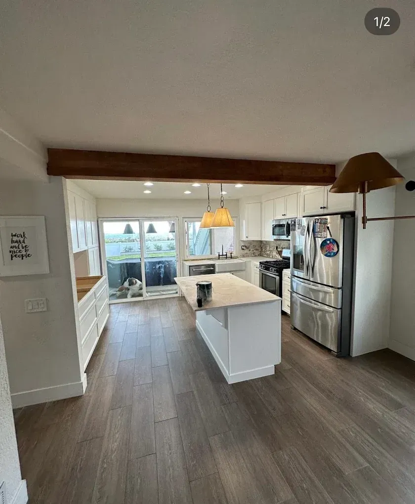 A kitchen with stainless steel appliances and a large island.