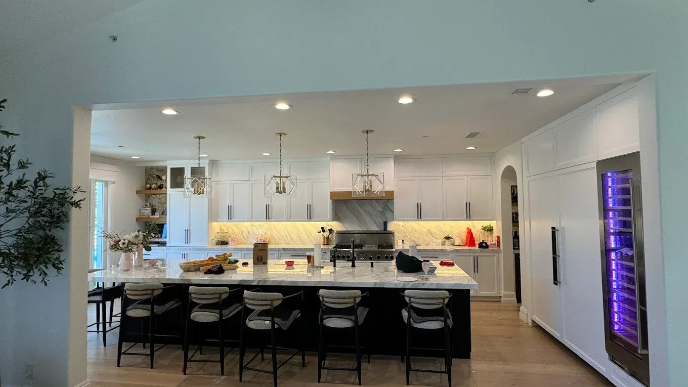 A large kitchen with a large island and stools.