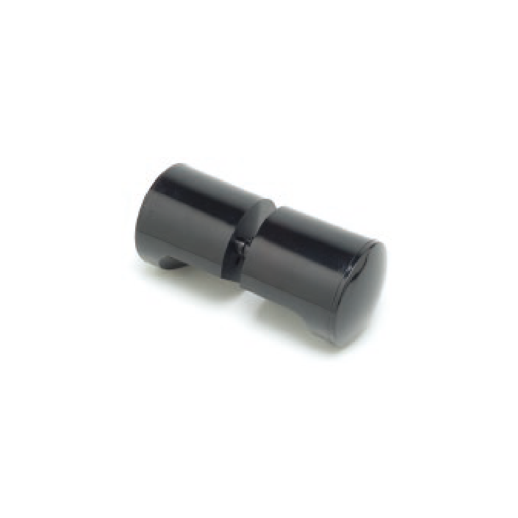 一個黑色塑膠旋鈕位於白色表面上。