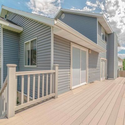 A house with a large deck and sliding glass doors