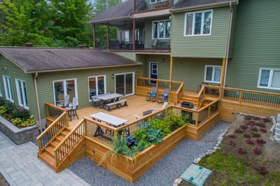An aerial view of a large wooden deck in front of a house.