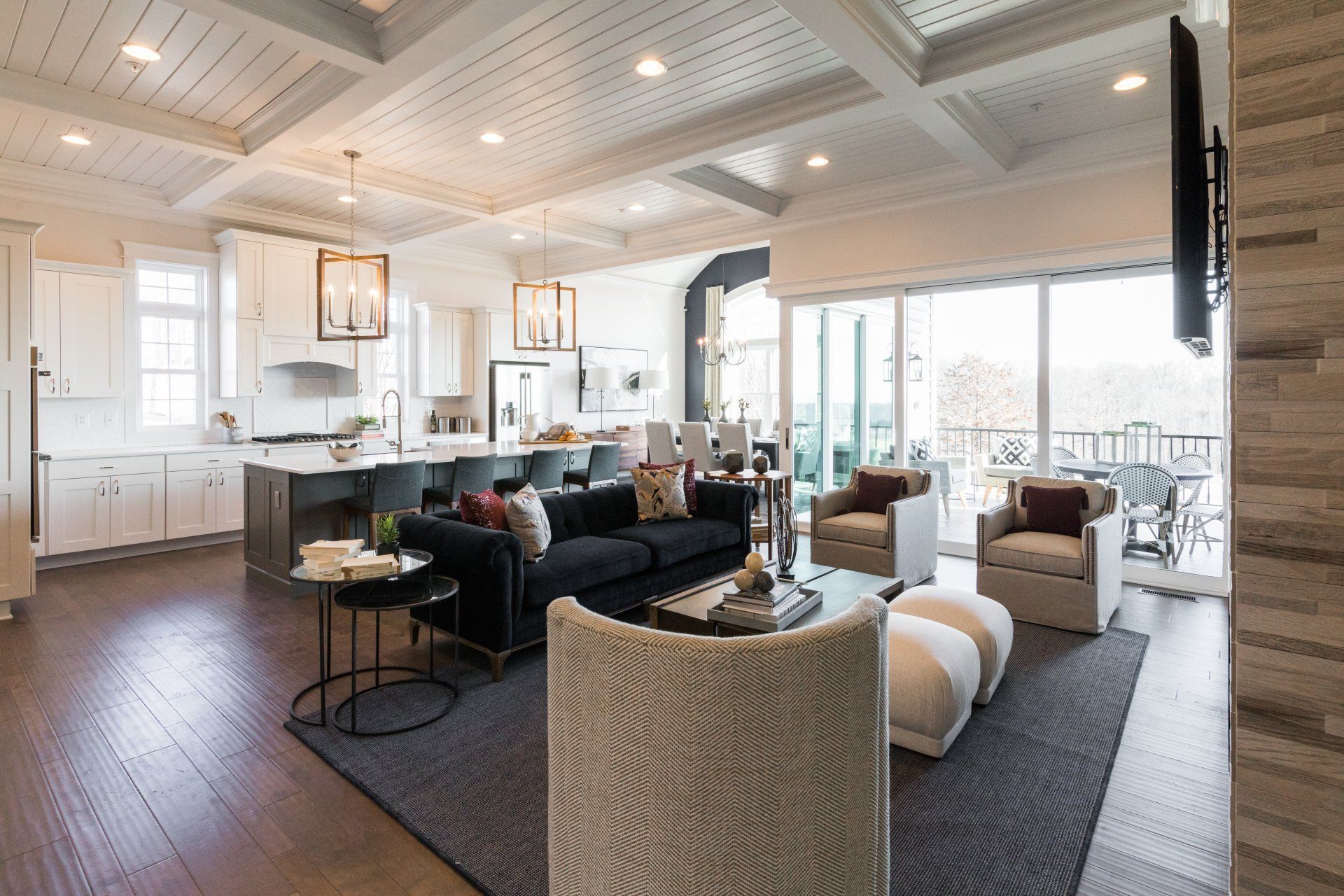 Spacious, open-concept living area with kitchen, seating area, and sliding doors to a patio.