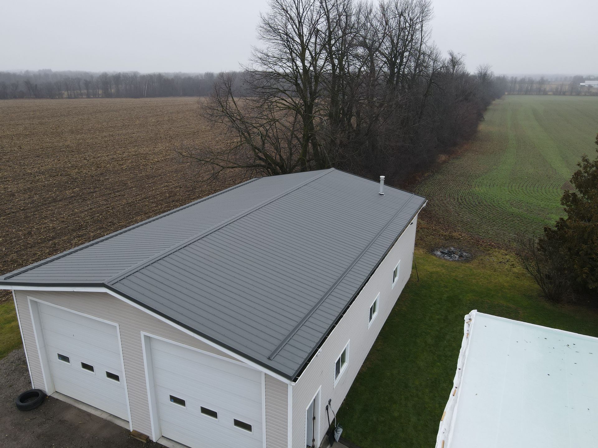An aerial view of a garage with a gray roof.