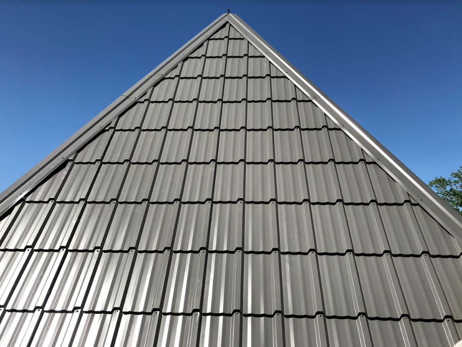 Looking up at a roof with a blue sky in the background