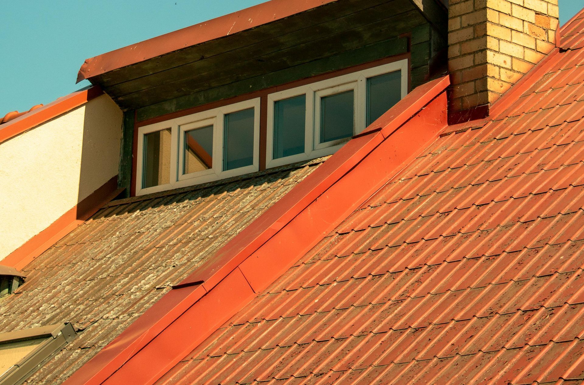House with sloped orange steel roof.