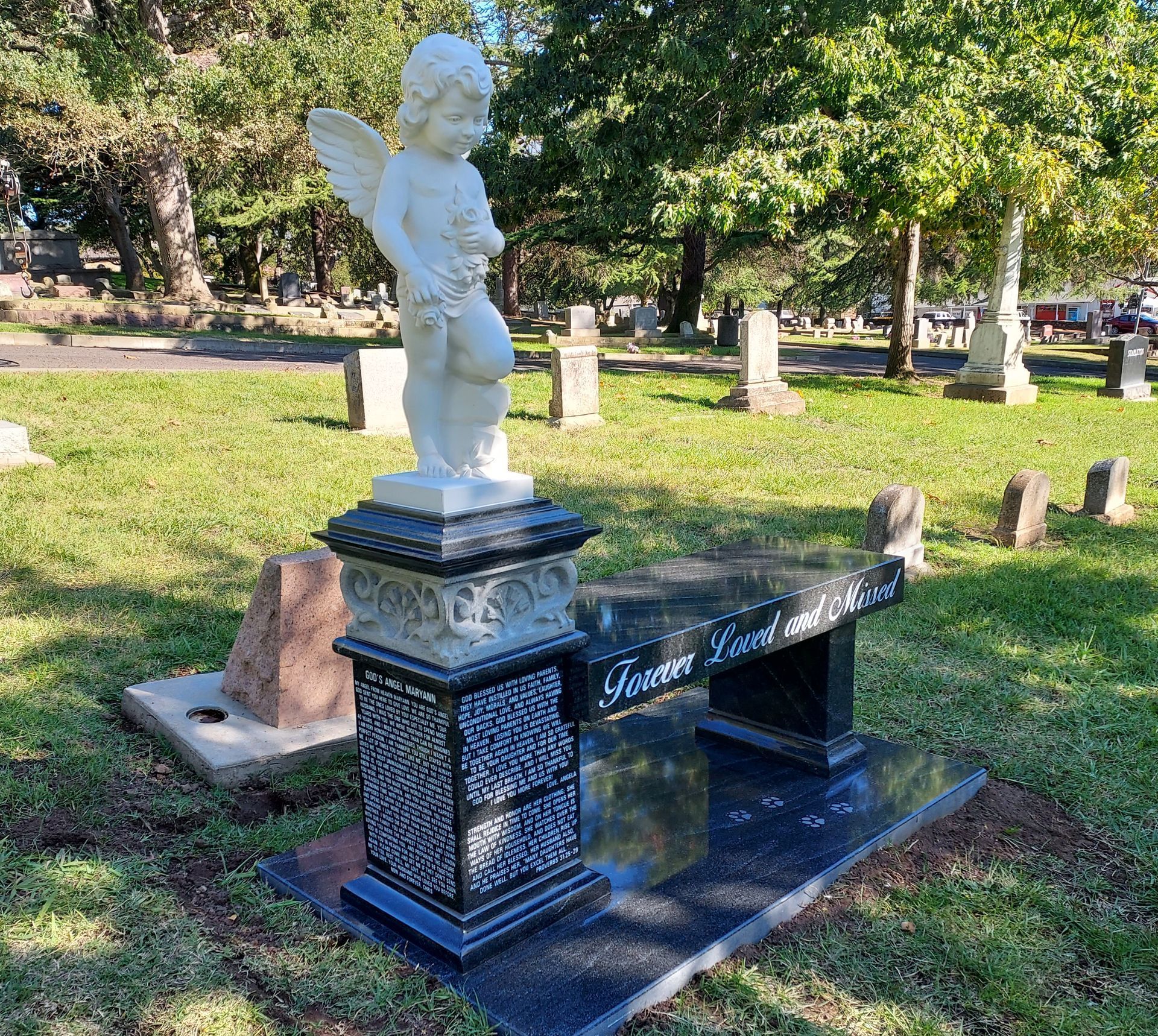 A vase of flowers is sitting on top of a grave.