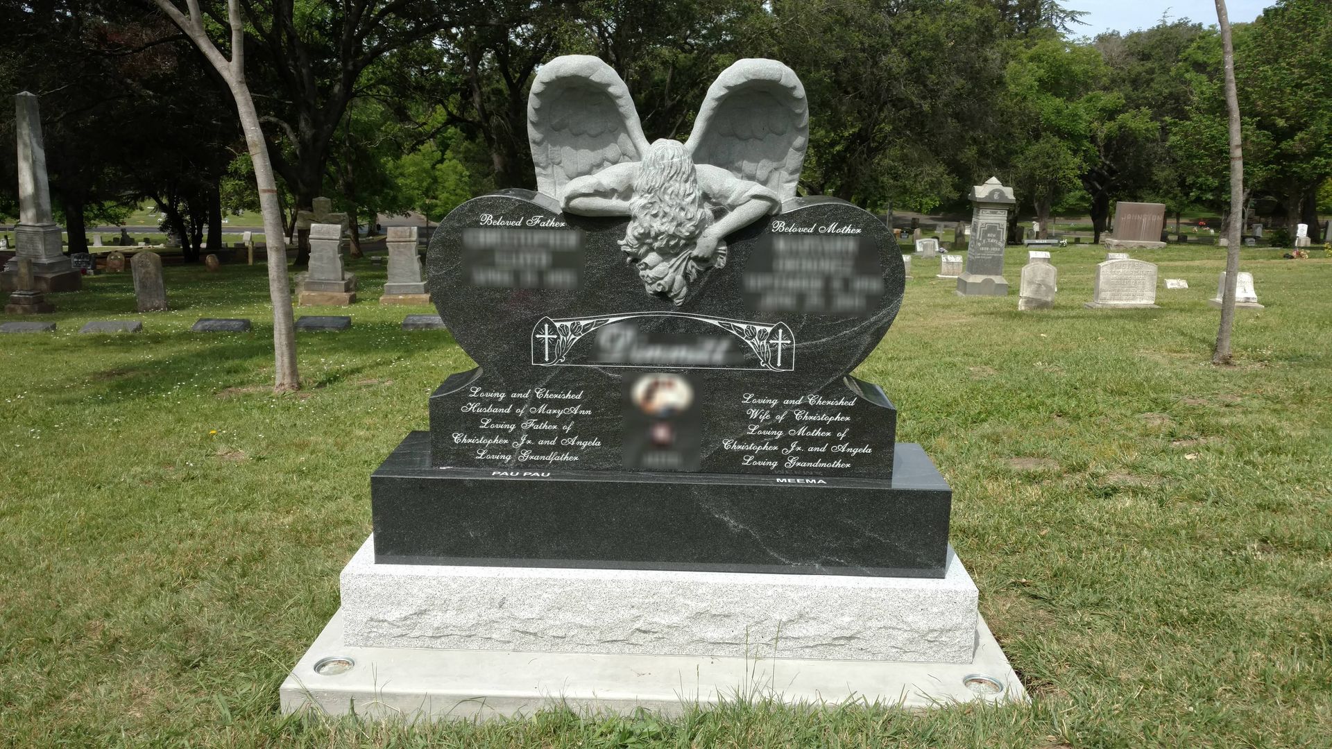 A vase of flowers is sitting on top of a grave.
